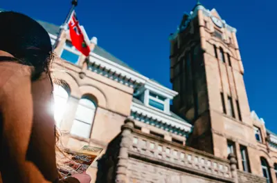 A person stands outside of City Hall