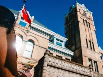 A person stands outside of City Hall