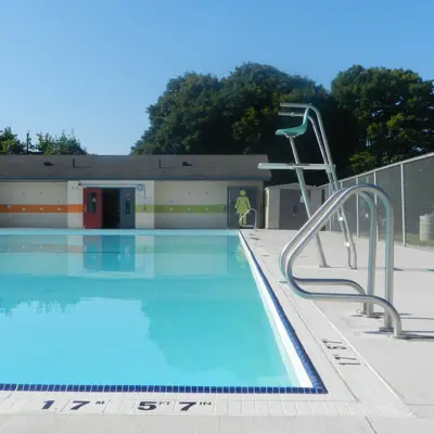 Public pool with changerooms and a lifeguard stand