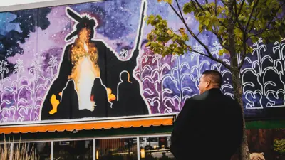 A colourful mural on the side of the St. Thomas Public Library